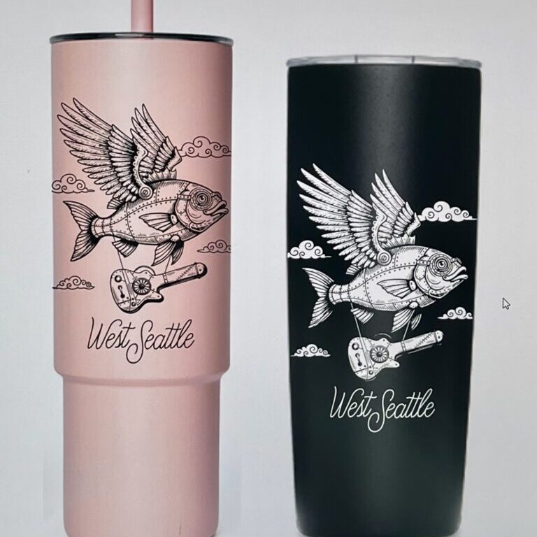 Two tumblers, one pink and one black, featuring an illustrated flying fish with gears, clouds, and a guitar, with the text "West Seattle" below the design.